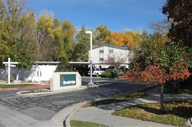 4853 S Woodbridge Dr E Unit 44, Salt Lake City, UT 84117 - view of asphalt street featuring sidewalks and curbs