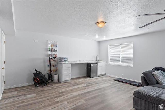 4868 W Cedar Point Peak Dr S, Riverton, UT 84096 - interior space with fridge, light wood finished floors, a sink, baseboards, and a textured ceiling