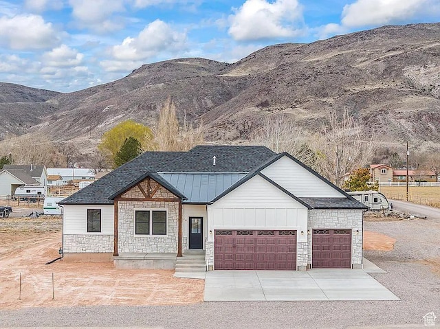281 N 460 E, Elsinore, UT 84724 - view of front of property featuring an attached garage, a mountain view, concrete driveway, and stone siding