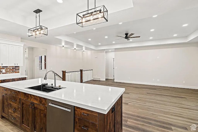 281 N 460 E, Elsinore, UT 84724 - kitchen featuring a sink, a tray ceiling, light wood finished floors, stainless steel dishwasher, and light countertops