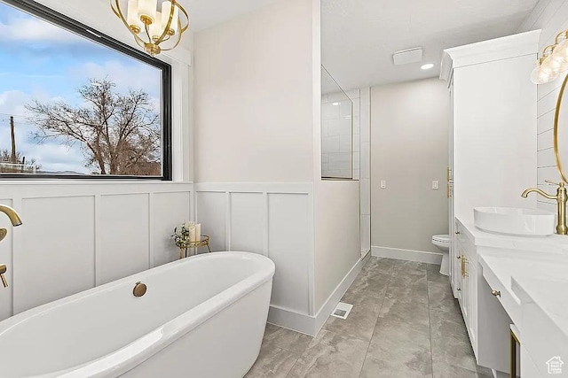 281 N 460 E, Elsinore, UT 84724 - bathroom featuring a freestanding tub, marble finish flooring, a decorative wall, toilet, and double vanity