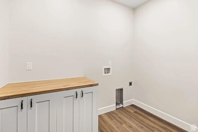 281 N 460 E, Elsinore, UT 84724 - washroom featuring hookup for a washing machine, electric dryer hookup, baseboards, light wood-style floors, and cabinet space
