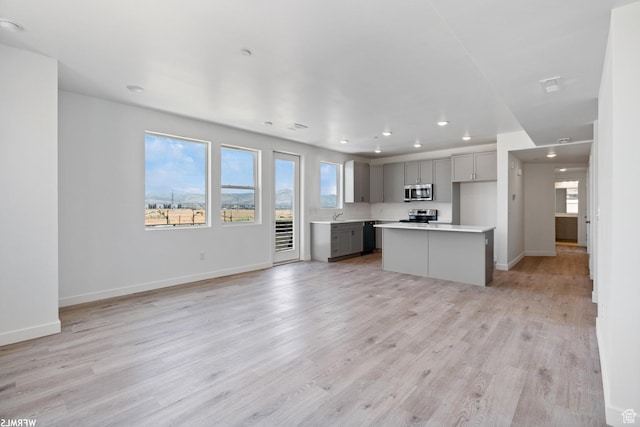 5263 W Reventon Rd S, South Jordan, UT 84009 - unfurnished living room with recessed lighting, healthy amount of natural light, and light wood-style floors