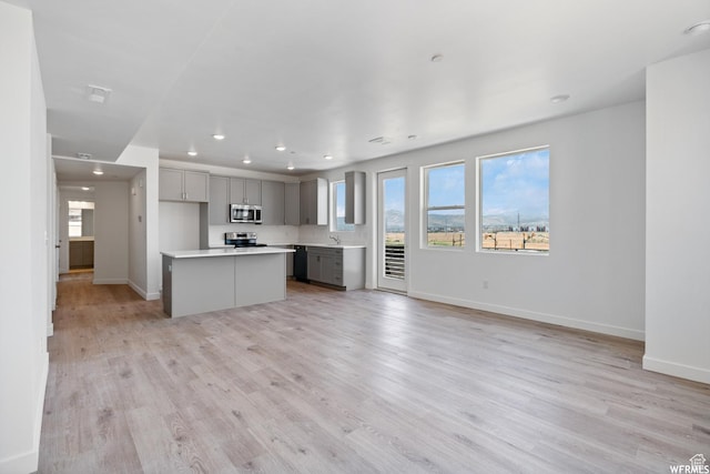 5263 W Reventon Rd S, South Jordan, UT 84009 - kitchen featuring appliances with stainless steel finishes, gray cabinetry, recessed lighting, open floor plan, and light countertops