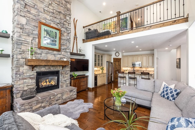 13279 N Alexis Dr, Kamas, UT 84036 - living area with wine cooler, a fireplace, dark wood-type flooring, a high ceiling, and recessed lighting