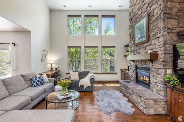 13279 N Alexis Dr, Kamas, UT 84036 - living area with a high ceiling, plenty of natural light, a stone fireplace, and wood finished floors