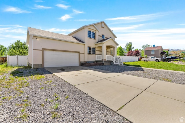 748 N 310 E, Tooele, UT 84074 - traditional-style house featuring an attached garage, driveway, stucco siding, and a porch