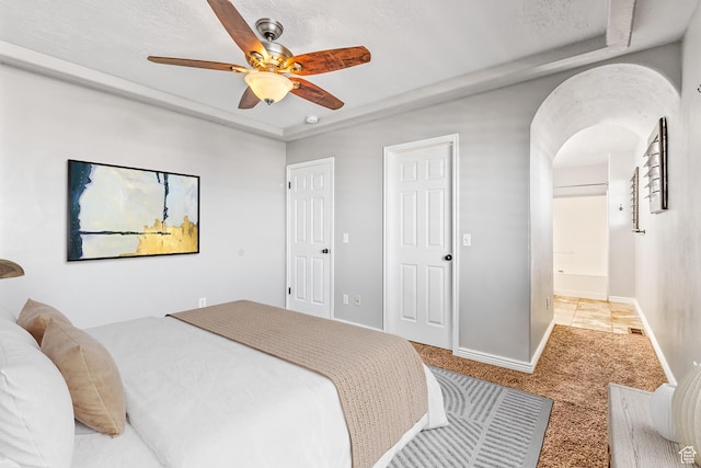 748 N 310 E, Tooele, UT 84074 - bedroom with carpet floors, baseboards, ceiling fan, arched walkways, and a raised ceiling