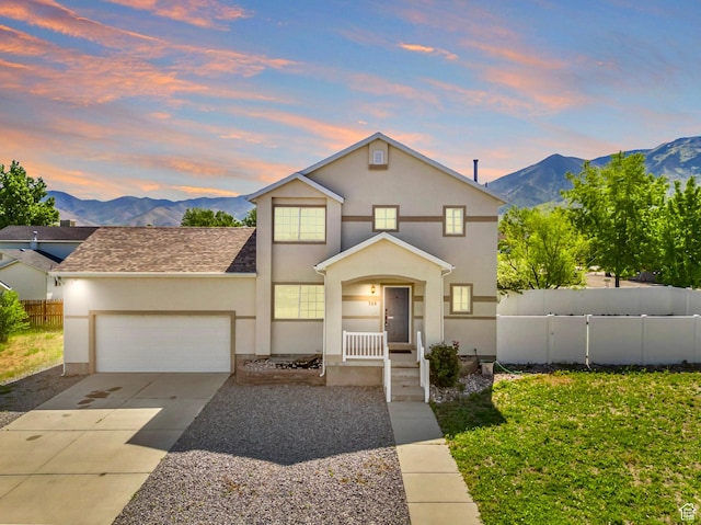 748 N 310 E, Tooele, UT 84074 - traditional home with a mountain view, stucco siding, a garage, and concrete driveway