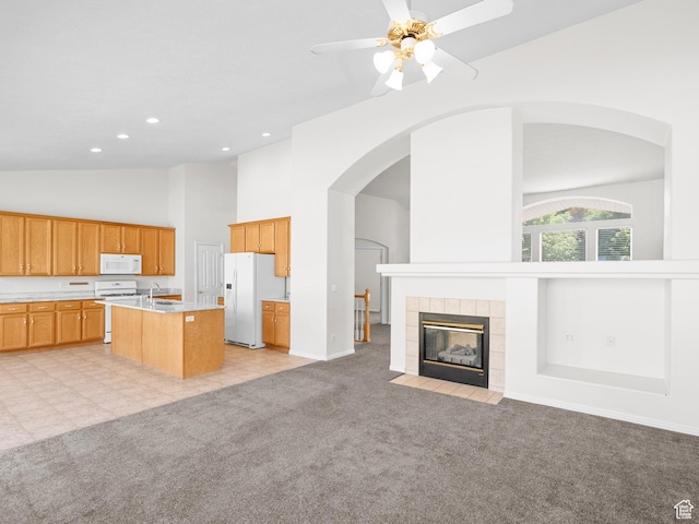 4912 W Rosewood Dr S, South Jordan, UT 84009 - kitchen featuring white appliances, open floor plan, high vaulted ceiling, light countertops, and light carpet