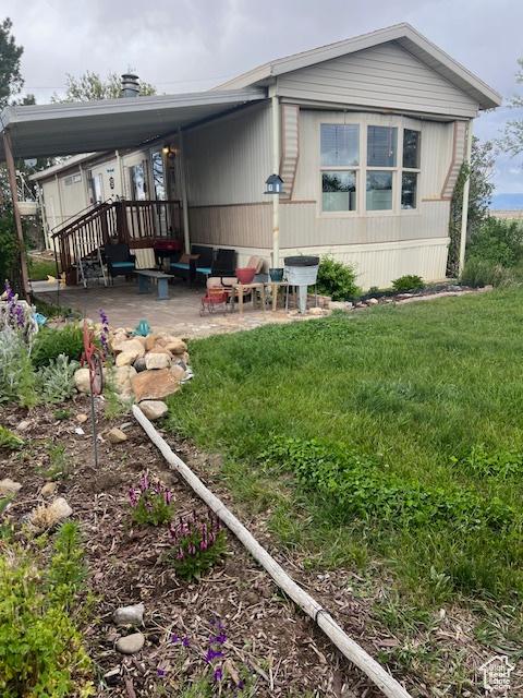415 E 100 N, Elmo, UT 84521 - back of house featuring a patio area and a yard
