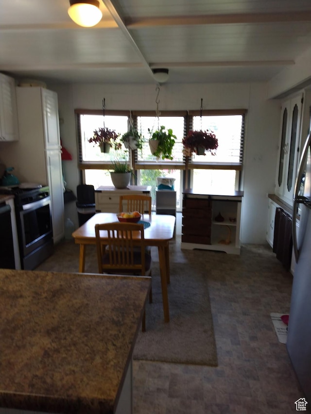415 E 100 N, Elmo, UT 84521 - kitchen with stainless steel electric stove, beam ceiling, and freestanding refrigerator