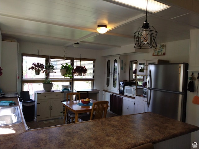415 E 100 N, Elmo, UT 84521 - kitchen with freestanding refrigerator, white microwave, white cabinetry, dark countertops, and a sink