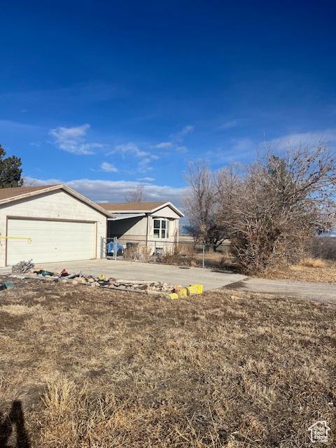 415 E 100 N, Elmo, UT 84521 - view of front of property featuring concrete driveway and a garage