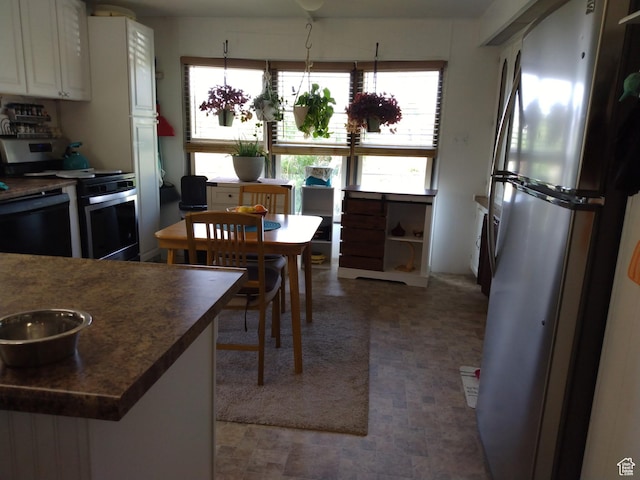 415 E 100 N, Elmo, UT 84521 - kitchen featuring stainless steel appliances, white cabinets, and dark countertops