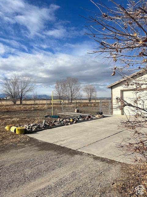 415 E 100 N, Elmo, UT 84521 - view of yard featuring concrete driveway and a garage