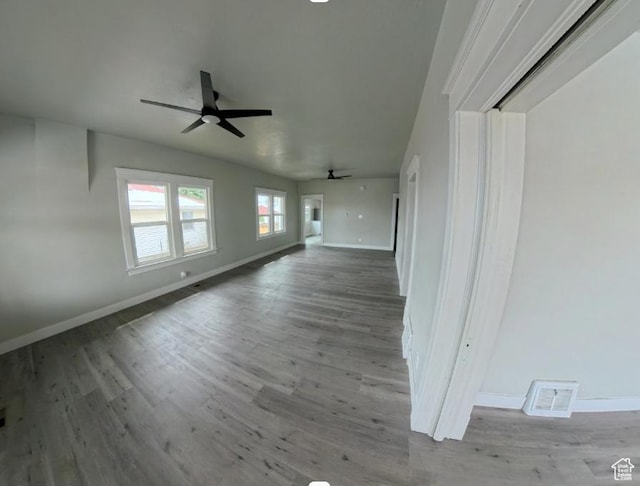 197 W Center St, Midvale, UT 84047 - unfurnished living room with a ceiling fan, baseboards, and wood finished floors