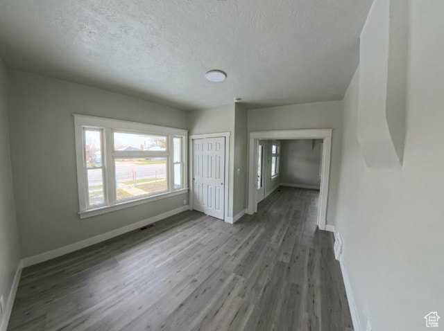 197 W Center St, Midvale, UT 84047 - empty room featuring wood finished floors, a textured ceiling, and baseboards