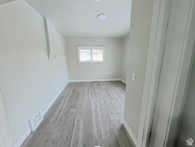 197 W Center St, Midvale, UT 84047 - empty room featuring wood finished floors, baseboards, and a textured ceiling