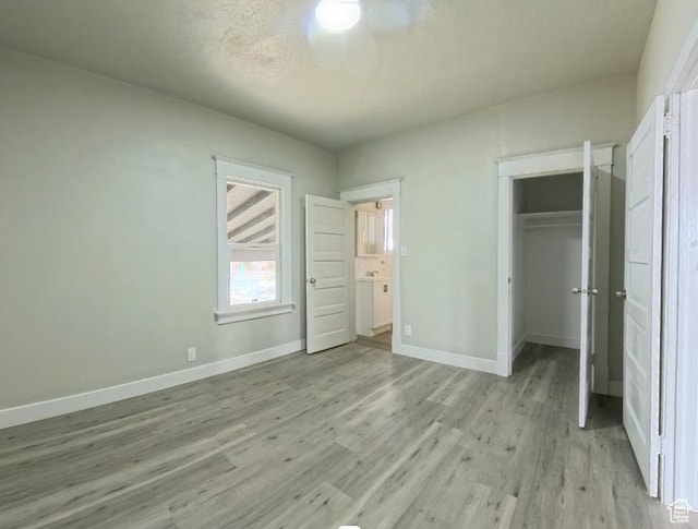 197 W Center St, Midvale, UT 84047 - unfurnished bedroom featuring baseboards, light wood-style floors, and a closet