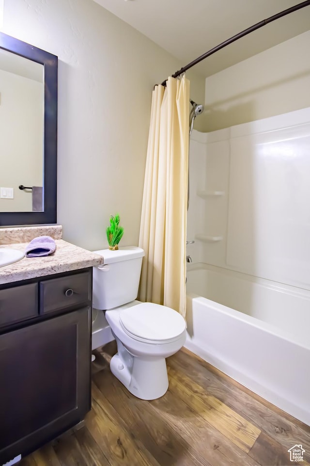 534 S Chan Dr, Grantsville, UT 84029 - full bathroom featuring vanity, toilet, wood finished floors, and shower / bath combination with curtain