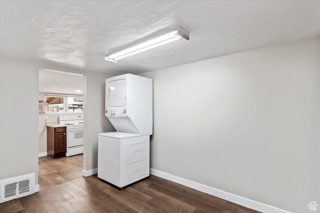 272 S State St, Clearfield, UT 84015 - washroom with estacked washer and dryer, baseboards, dark wood finished floors, and a textured ceiling