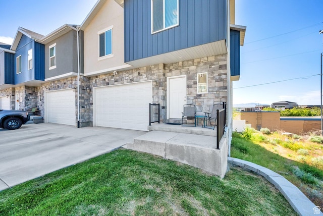 20 S Walker Ln, North Salt Lake, UT 84054 - view of front of home with stone siding, an attached garage, and driveway