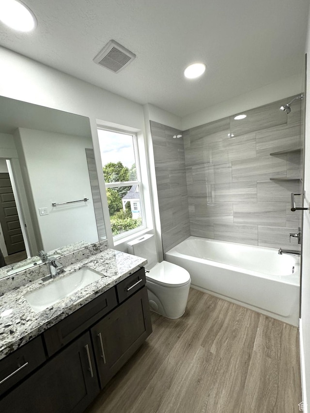 1189 E Benchview Dr, Ogden, UT 84404 - full bathroom with toilet, wood finished floors, vanity, shower / washtub combination, and recessed lighting