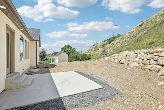 1189 E Benchview Dr, Ogden, UT 84404 - view of patio / terrace featuring an outbuilding