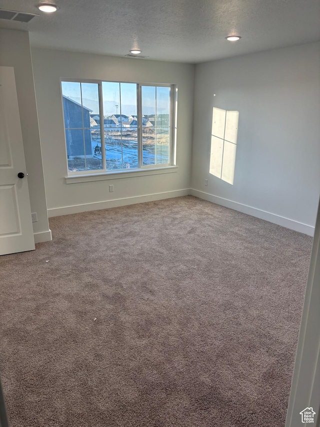 718 N 280 E, Tooele, UT 84074 - carpeted empty room with baseboards and a textured ceiling
