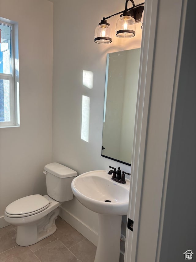 718 N 280 E, Tooele, UT 84074 - half bathroom with baseboards, tile patterned flooring, toilet, and healthy amount of natural light