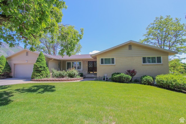 1460 E 2100 N, North Logan, UT 84341 - single story home with brick siding, a garage, a front lawn, and concrete driveway