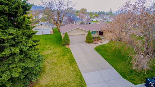 1460 E 2100 N, North Logan, UT 84341 - view of front of home featuring a garage, a front yard, a residential view, and driveway