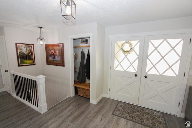 1460 E 2100 N, North Logan, UT 84341 - foyer entrance featuring wood finished floors, baseboards, and a textured ceiling