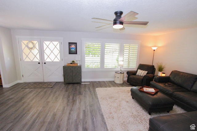 1460 E 2100 N, North Logan, UT 84341 - living room featuring wood finished floors, a ceiling fan, and baseboards