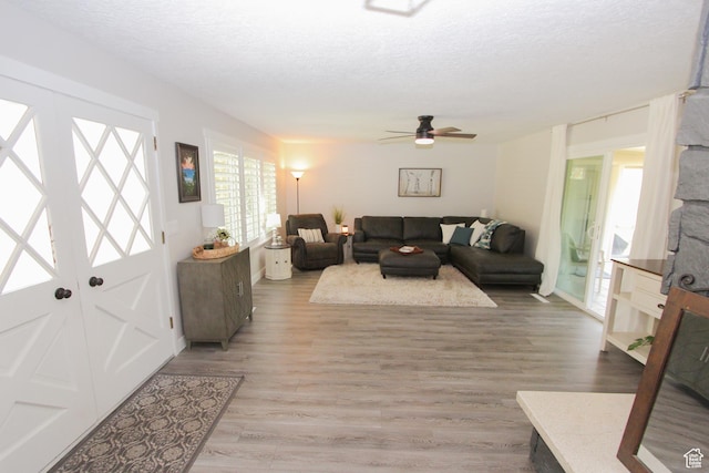 1460 E 2100 N, North Logan, UT 84341 - living area featuring ceiling fan, light wood-type flooring, and a textured ceiling