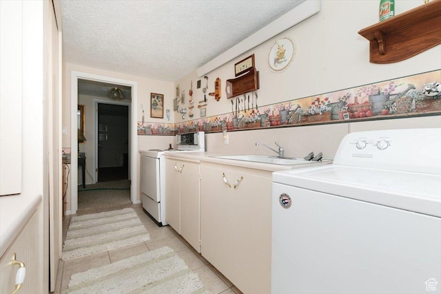 310 E Valley View Dr, Preston, ID 83263 - laundry room featuring cabinet space, light tile patterned floors, a textured ceiling, and independent washer and dryer