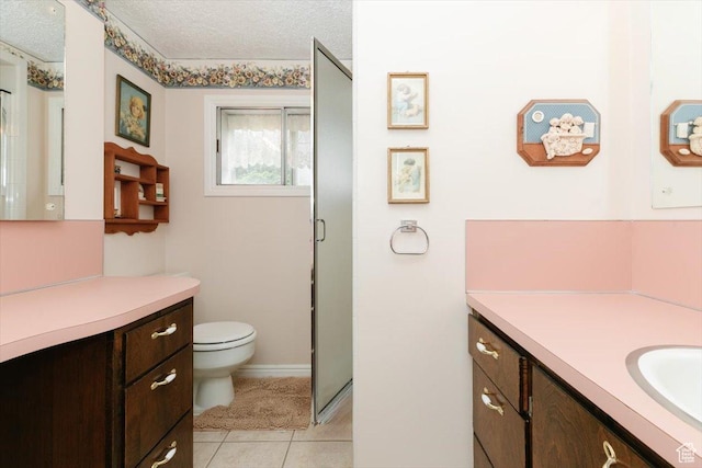 310 E Valley View Dr, Preston, ID 83263 - bathroom with vanity, toilet, tile patterned flooring, a shower stall, and a textured ceiling