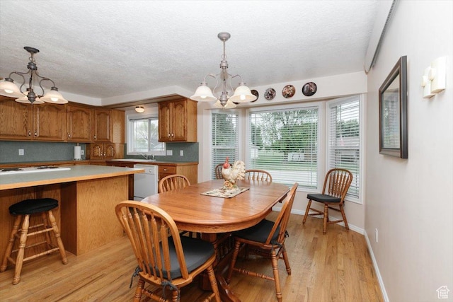 310 E Valley View Dr, Preston, ID 83263 - dining room with a chandelier, a textured ceiling, light wood-type flooring, and baseboards