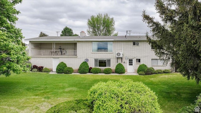 310 E Valley View Dr, Preston, ID 83263 - rear view of property with a lawn, a chimney, brick siding, and a balcony