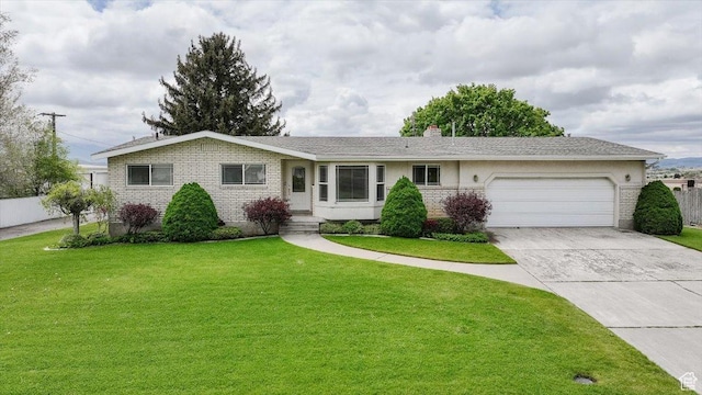 310 E Valley View Dr, Preston, ID 83263 - ranch-style house featuring a garage, concrete driveway, a chimney, and brick siding