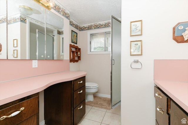 310 E Valley View Dr, Preston, ID 83263 - full bath featuring vanity, toilet, a stall shower, a textured ceiling, and tile patterned floors