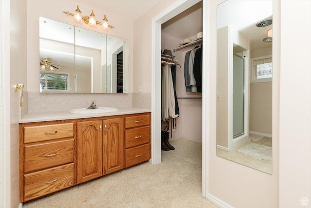 310 E Valley View Dr, Preston, ID 83263 - bathroom with vanity, a spacious closet, an enclosed shower, and carpet floors