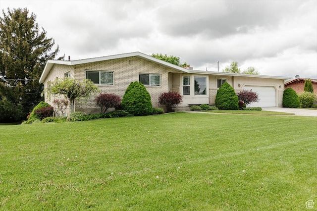 310 E Valley View Dr, Preston, ID 83263 - ranch-style house featuring a garage, concrete driveway, a front lawn, and brick siding