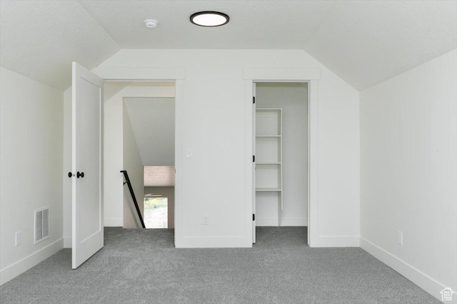821 E 160 N, Hyde Park, UT 84318 - unfurnished bedroom featuring lofted ceiling, carpet flooring, a walk in closet, a closet, and baseboards