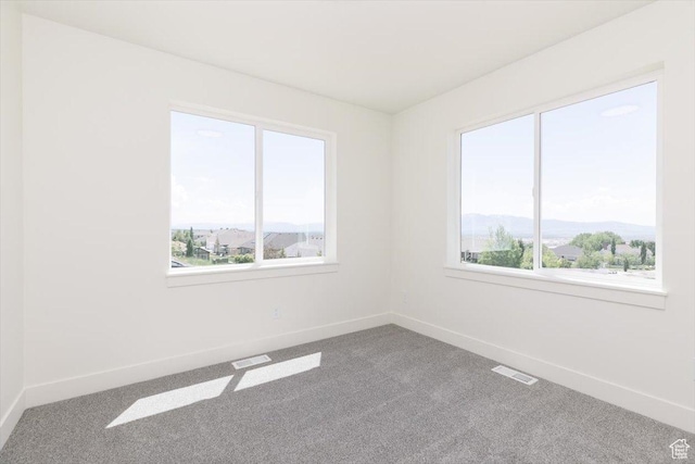 821 E 160 N, Hyde Park, UT 84318 - carpeted empty room with baseboards and a mountain view