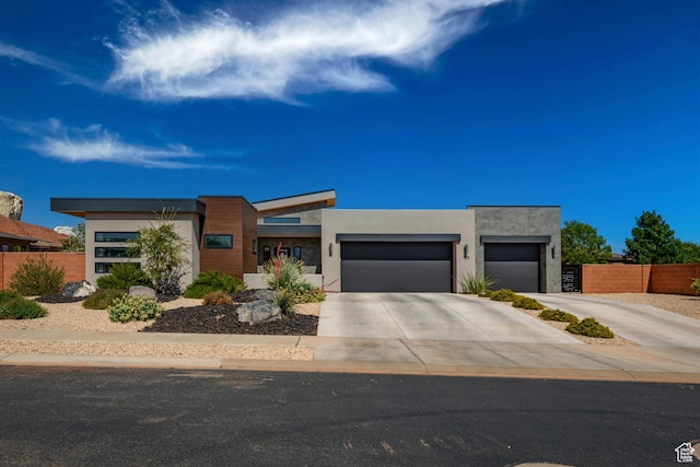 108 N Arrowhead Ln, Ivins, UT 84738 - contemporary house featuring a garage, concrete driveway, and stucco siding