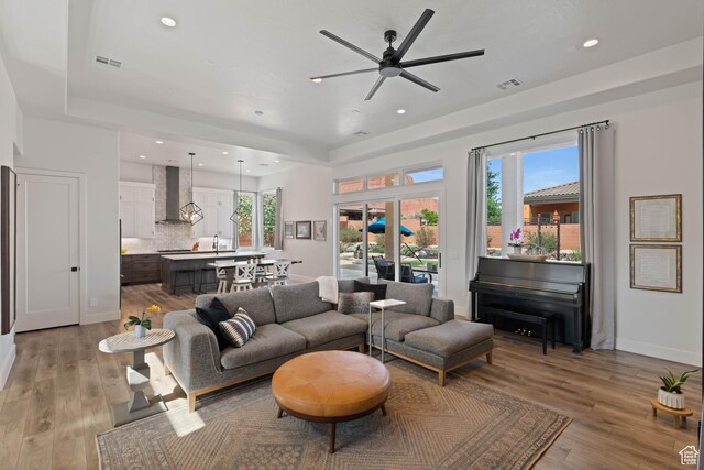 108 N Arrowhead Ln, Ivins, UT 84738 - living area featuring ceiling fan, recessed lighting, light wood-style flooring, a raised ceiling, and baseboards