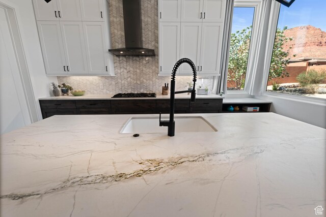 108 N Arrowhead Ln, Ivins, UT 84738 - kitchen featuring wall chimney range hood, gas stovetop, plenty of natural light, and light stone countertops