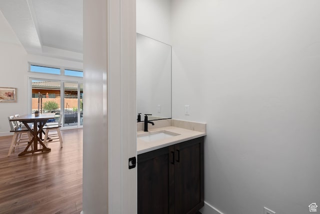 108 N Arrowhead Ln, Ivins, UT 84738 - bathroom featuring wood finished floors, vanity, baseboards, and a tray ceiling